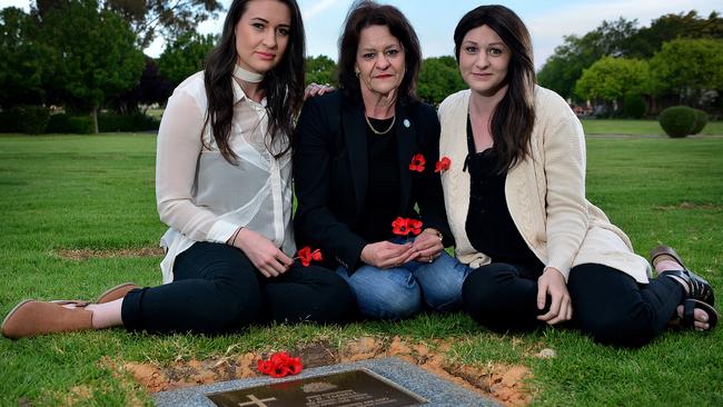 Vicki Crannaford (centre) with her daughters Meegan & Brooke at the veteran memorial grave of their grandfather and uncle, at Enfield Memorial Park. The body of Vicki's brother was brought back to Australia this year, after he died during battle in 1966 picture: Bianca De Marchi