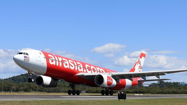 The inaugural Air Asia flight between the Gold Coast and Auckland City in New Zealand, Captain Jay Schledge and Mikey Long stand proudly in front of the Air Asia Airbus.