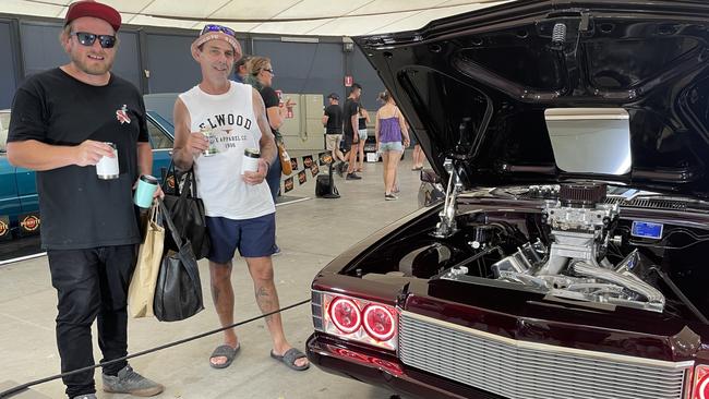 Geelong's Jarrod Turner and Seymour's Brett Mathieson check out a classic car at Meatstock 2023 at the Melbourne Showgrounds.