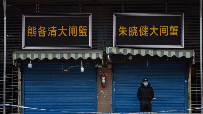 A security guard stands outside the Huanan Seafood Wholesale Market where the coronavirus was detected in Wuhan on January 24, 2020. Picture: AFP