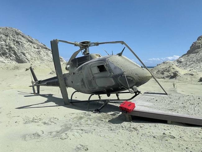 A damaged helicopter is seen on White Island after the deadly eruption. Photo: Instagram