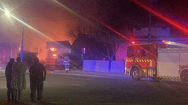 Witnesses look on as a fire tears through Signlab on Port Rd, Alberton. Picture: George Yankovich