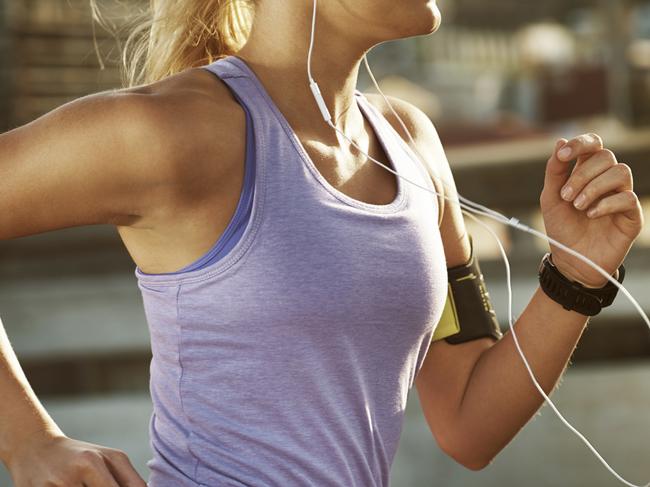 Cropped shot of a fit young woman running in an urban setting