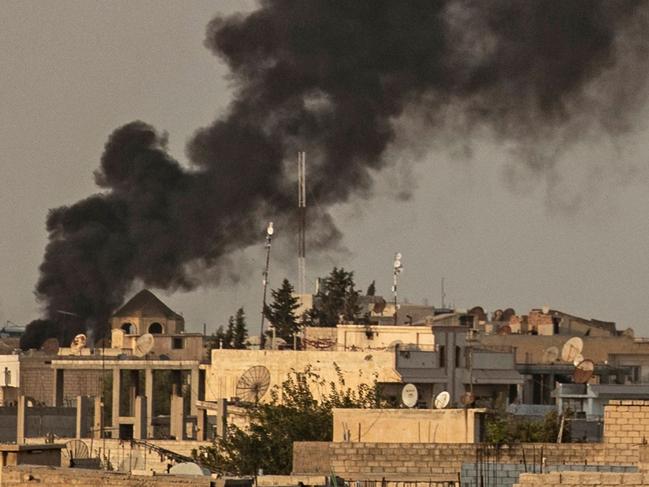 Smoke billows following Turkish bombardment on Syria's northeastern town of Ras al-Ain in the Hasakeh province along the Turkish border on October 9, 2019. - Turkey launched an assault on Kurdish forces in northern Syria with air strikes and explosions reported along the border. President Recep Tayyip Erdogan announced the start of the attack on Twitter, labelling it "Operation Peace Spring". (Photo by Delil SOULEIMAN / AFP)