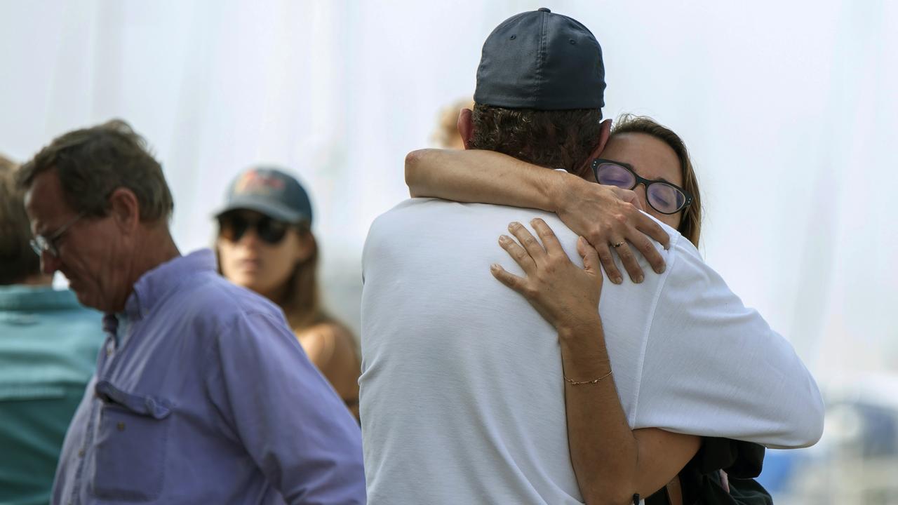 People hug each other as they await news outside of the Truth Aquatics office in Santa Barbara. Picture: AP Photo/Christian Monterrosa.