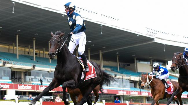 Boss rises in stirrups as Sir Dragonet crosses the finish line. Picture: Getty Images