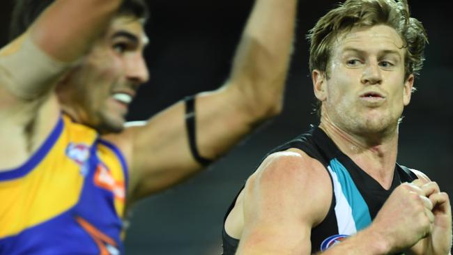 Tom Jonas moves in to collide with West Coast’s Andrew Gaff. Picture: Mark Brake