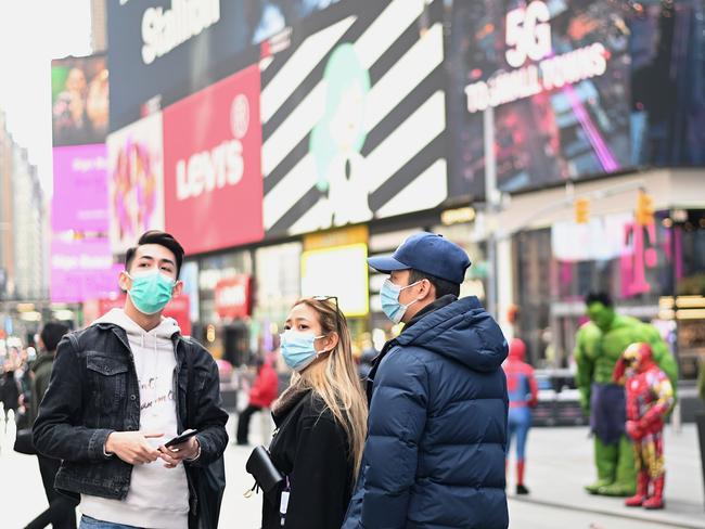 Tourists in an eerily quiet Times Square. Picture: AFP