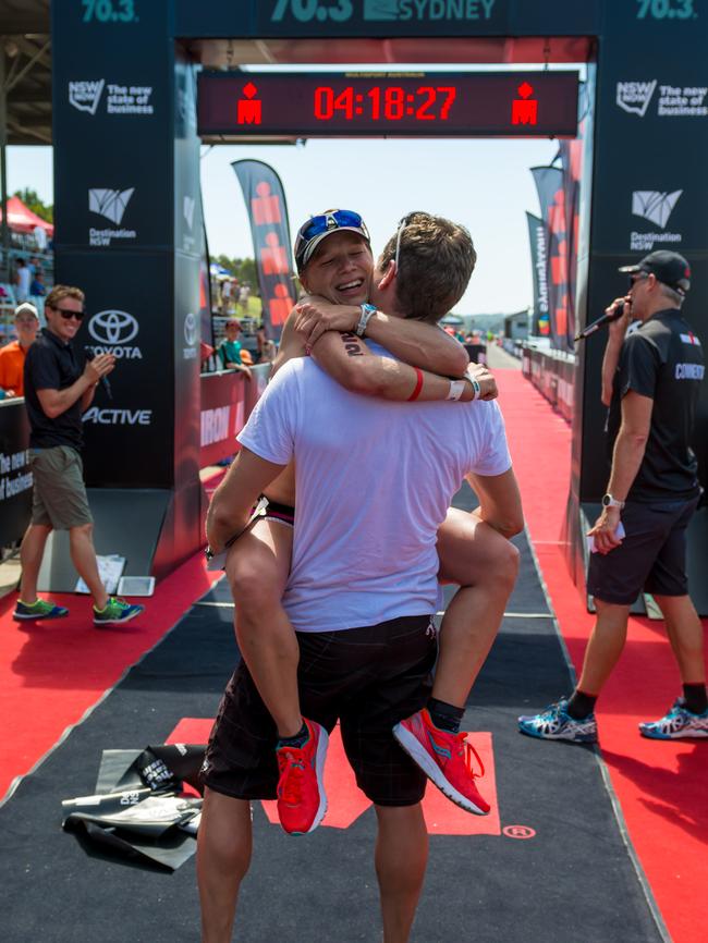 Womens winner Anja Beranek sees her husband on the finish line at the IRONMAN Western Sydney 70.3. (JGRimages)