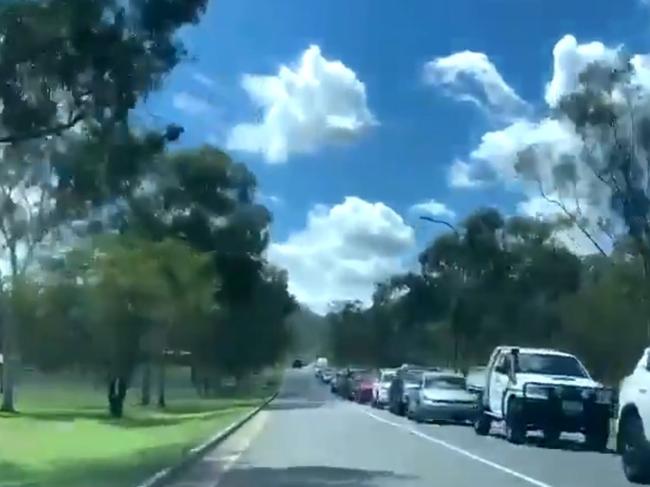 This is a queue for one COVID testing clinic in Rockhampton after a man visited Gladstone, not knowing he was infectious with the UK strain of COVID-19. Still from a video. Picture: Isla Stanich/Twitter/7NewsCQ