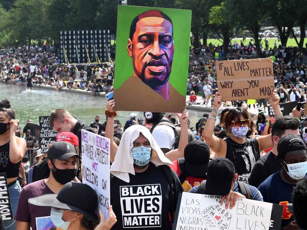 Demonstrators in the US hold a painting of George Floyd as they protest against racism and police brutality. Picture: Eric Baradat / AFP