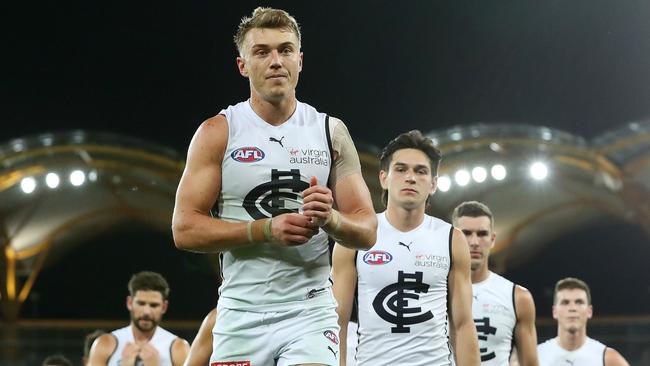 Patrick Cripps leads his teammates off Metricon Stadium after the Blues threw away victory against the Giants. Picture: Michael Klein