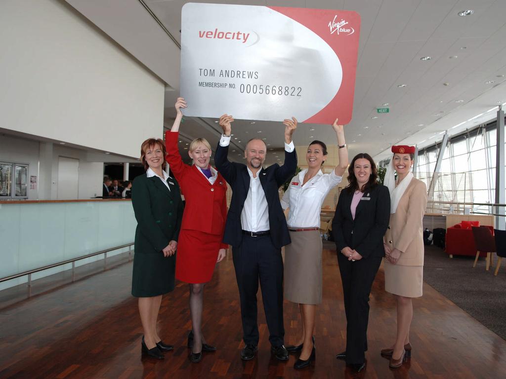 Brett Godfrey, former Virgin Blue chief executive officer, with the Velocity card (a frequent flyer card) and staff from all their partners, when it launched back in 2005. Picture: James Morgan.