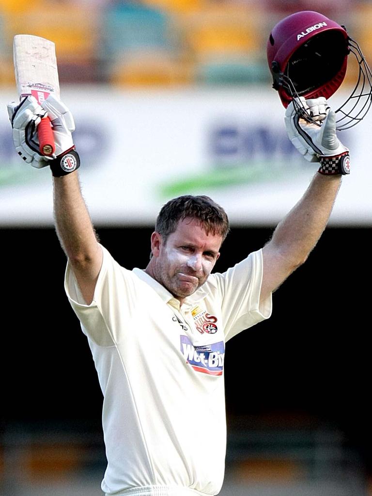 Martin Love celebrates scoring a century for Queensland.