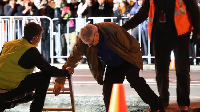 Mike Parr is helped into the underground chamber in Macquarie St last week. Picture: NIKKI DAVIS-JONES