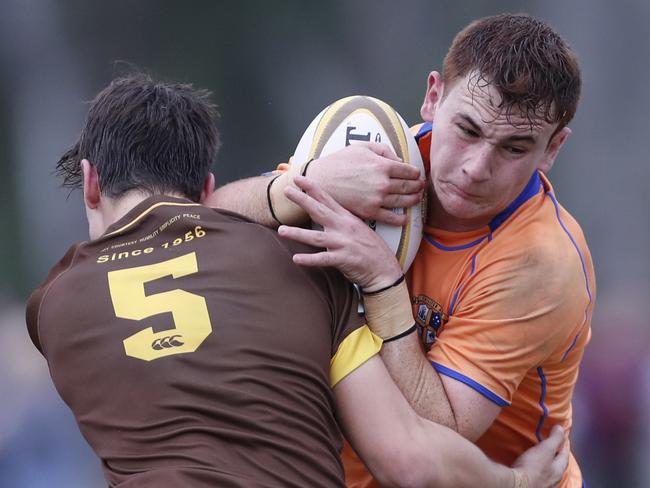 Josh Radford (right) of Marist College Ashgrove is tackled by Lachlan McKenzie of Padua College during the school boys AIC rugby union match played at the Padua College ground in Banyo, Brisbane, Saturday, June 8, 2019. (AAP Image/Regi Varghese)