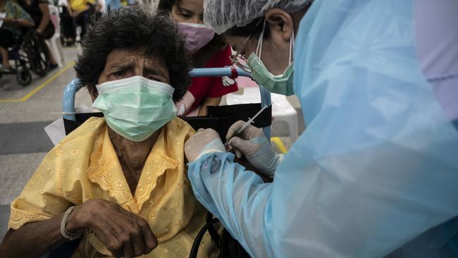 An elderly woman is administered with the AstraZeneca coronavirus vaccine at Central Vaccination Centre in Bang Sue Grand Station in Bangkok, Thailand. Picture: Getty Images