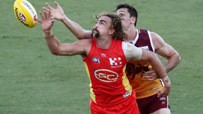 Gold Coast’s Brayden Crossley competes for the ball with Brisbane’s Oscar McInerney. Picture: Getty Images