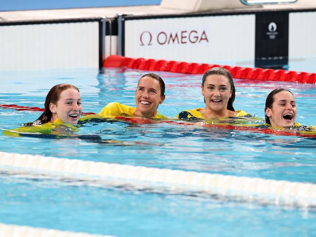 Mollie O’Callaghan, Emma McKeon, Jenna Strauch and Kaylee McKeown jump into the pool after winning silver in the medley relay. Picture: Adam Head