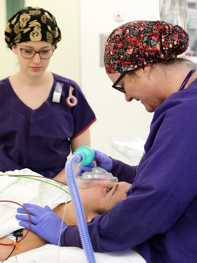 Nurses attend to Natalie Kellalea before the world-first procedure to deliver epilepsy drugs directly to her brain. Picture Andrew Tauber