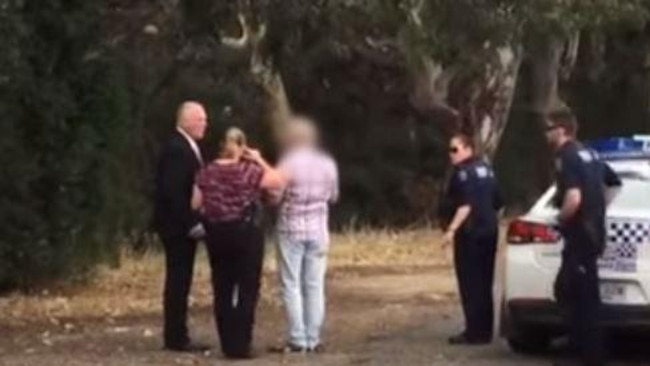 A man is taken away by police at Torrens Park train station after a confrontation with an anti-paedophile vigilante earlier this week, in an incident not connected with the second sting.