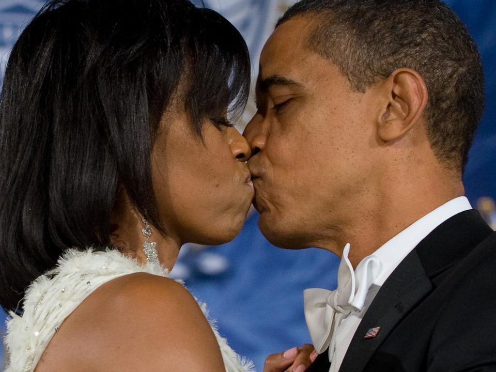 US President Barack Obama kisses wife and first lady Michelle as they dance at the Eastern Regional Inaugural Ball. Picture: Supplied