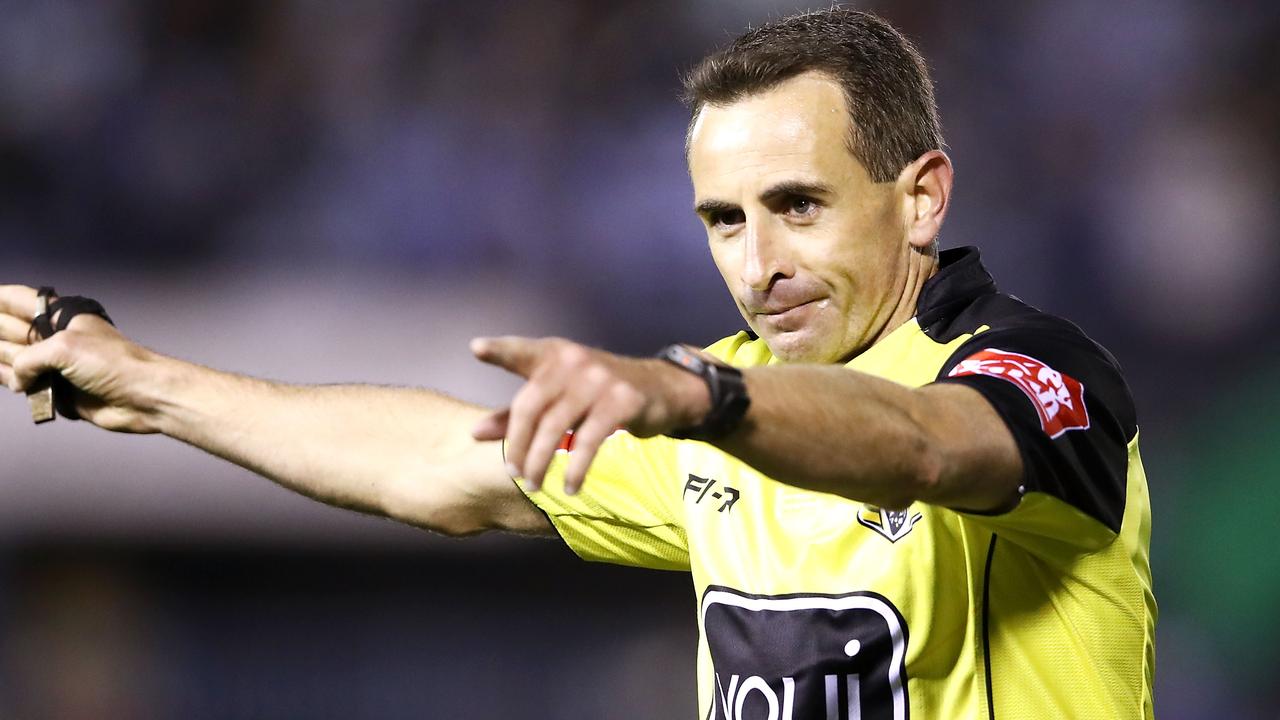 Referee Gerard Sutton awards a penalty.