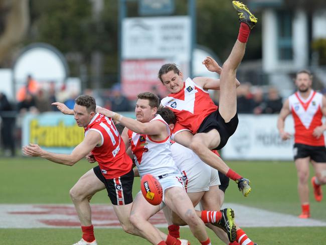 Karingal’s Brandon Wapshott tries to spoil Red Hill’s Sean Holmes (left) and Zach Vines. Picture: Chris Eastman