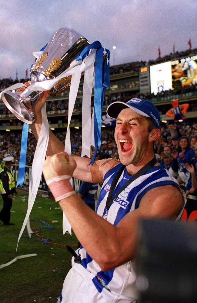 Footballer Corey McKernan holding AFL Premiership cup trophy. AFL Football in 1999.