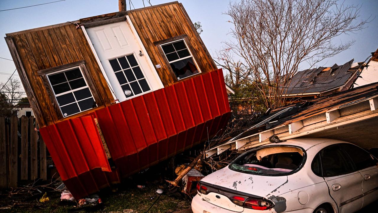 The remains of a crushed house and cars are seen in Rolling Fork, Mississippi. Picture: Chandan Khanna / AFP