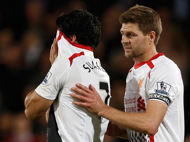 Liverpool's English midfielder Steven Gerrard (R) shepherds Liverpool's Uruguayan striker Luis Suarez (L) from the field as he reacts at the end of the English Premier League football match between Crystal Palace and Liverpool at Selhurst Park in south London on May 5, 2014. The match ended in a 3-3 draw. AFP PHOTO / ADRIAN DENNIS RESTRICTED TO EDITORIAL USE. No use with unauthorized audio, video, data, fixture lists, club/league logos or “live” services. Online in-match use limited to 45 images, no video emulation. No use in betting, games or single club/league/player publications.