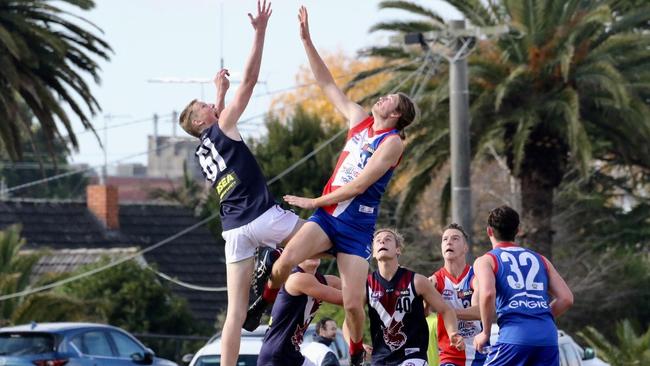 Max Heath (left) springs into a ruck contest for Sandy Dragons.