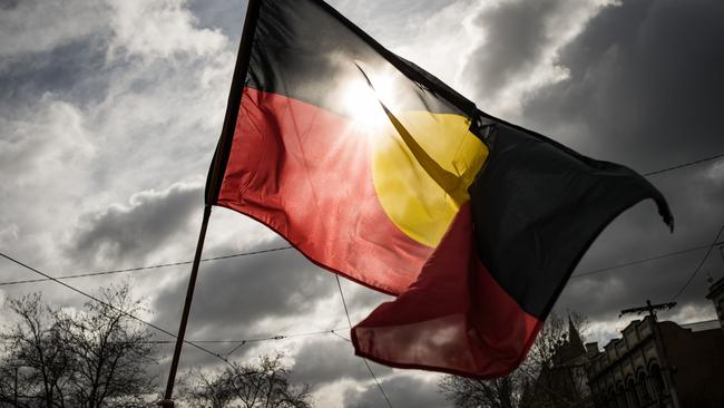 MELBOURNE, AUSTRALIA - JULY 07: The Aboriginal flag is seen flying during the NAIDOC March on July 07, 2023 in Melbourne, Australia. NAIDOC Week is an Australian observance lasting from the first Sunday in July until the following Sunday. The acronym NAIDOC stands for National Aborigines and Islanders Day Observance Committee. The week is intended as a time when all Australians can reflect on the rich history of the country's indigenous peoples, and learn about the cultures and histories of first nations groups. (Photo by Darrian Traynor/Getty Images)