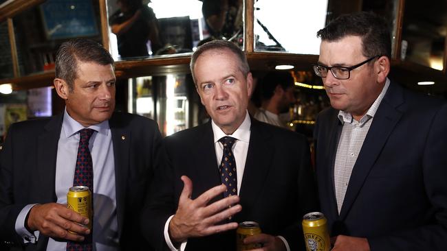 Labor Leader Bill Shorten, with Victorian Premier Daniel Andrews and former premier Steve Bracks, have a beer in memory of Bob Hawke in Melbourne on Friday night. Picture: Getty