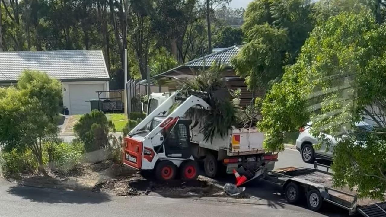 Council workers pictured clearing a teardrop garden in Helensvale. Picture: Helensvale Community Group / Facebook