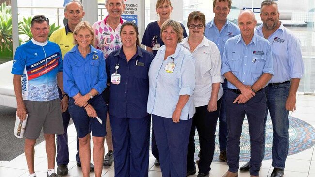 Roy Doutreband at left with Mark Henschke third from left at back present a cheque at Coffs Harbour hospital in 2017 after the Tour de Rocks Charity Bike Ride.