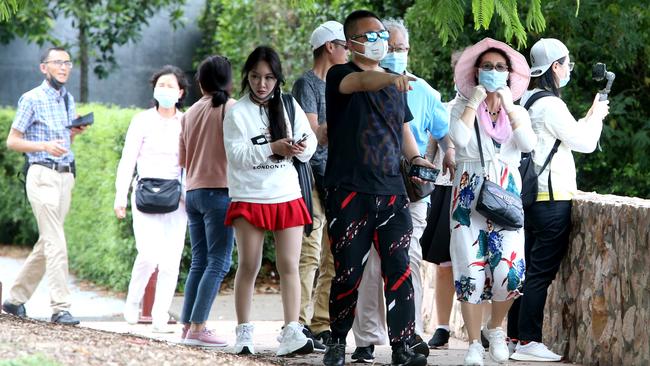 Tourists at Kangaroo Point wearing face masks, possibly because of coronavirus outbreak. Picture: Steve Pohlner/AAP