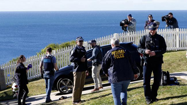 AFP officers swarming through the grounds of the luxury home. Picture: AAP