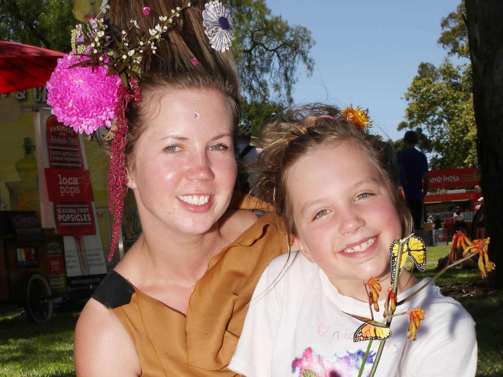 Amy Graham with daughter Paige, 7, with flowers left over from the French Festival. Picture: AAP/Emma Brasier