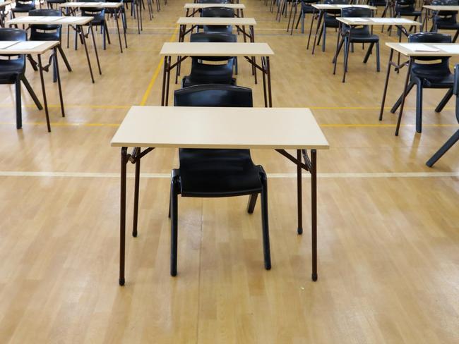 series of views of an examination hall or room images with exam tables set up ready for students. empty chairs and tables.   End of school exams university entrance or higher school certificate scene.