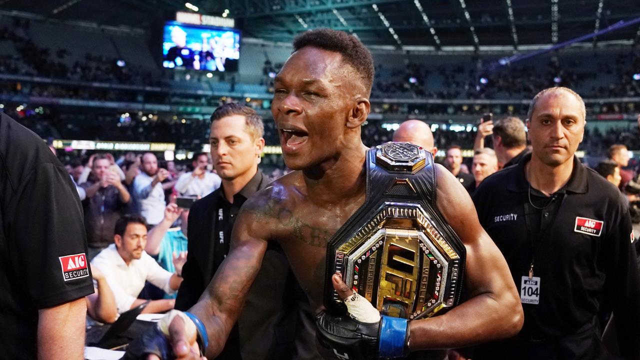 Adesanya with his UFC world title belt.