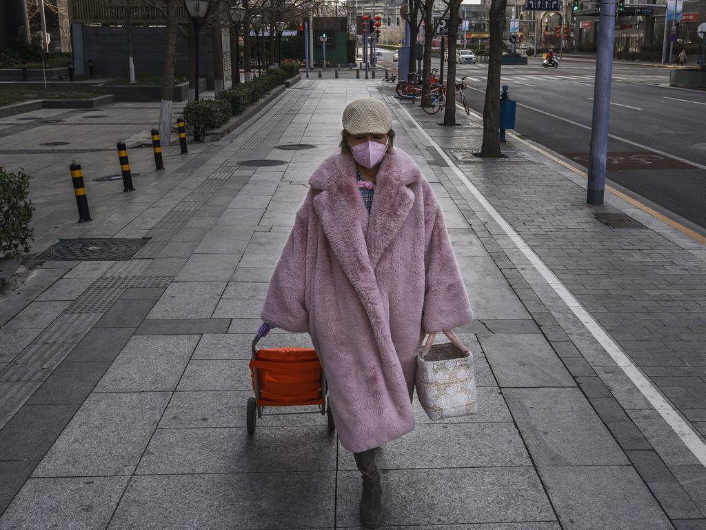 A pedestrian wears a protective mask walking in an empty area of Beijing. Picture: Kevin Frayer/Getty Images.