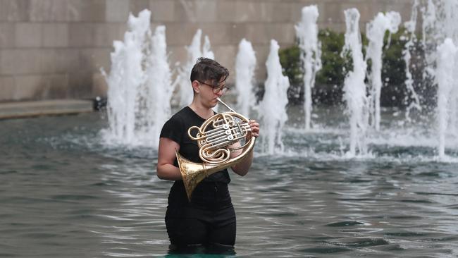 One protester was in the water playing the French horn. Picture: David Crosling