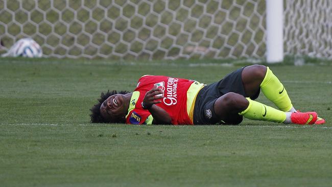 Brazil's Willian grimaces in pain, after falling to the ground, at training. Bad timing!