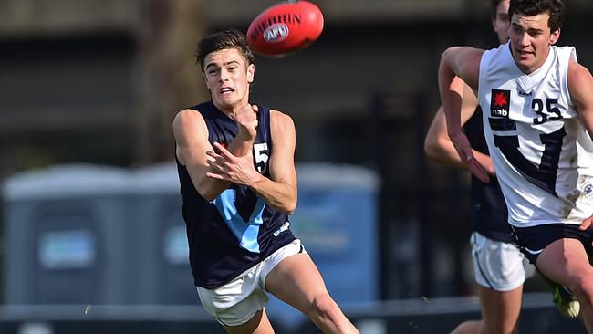 Patrick Naish gets a handball away for Vic Metro in the National Championships. Picture: Stephen Harman