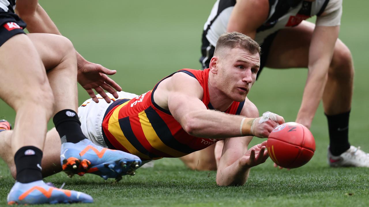 Rory Laird of the Crows gets a handball away. Picture: Michael Klein