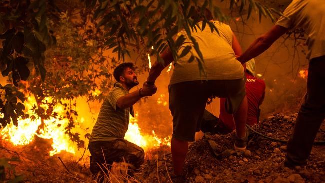 Local residents fight a wildfire in the village of Gouves on Evia (Euboea) island, the second-largest Greek island, earlier this week. Picture: AFP