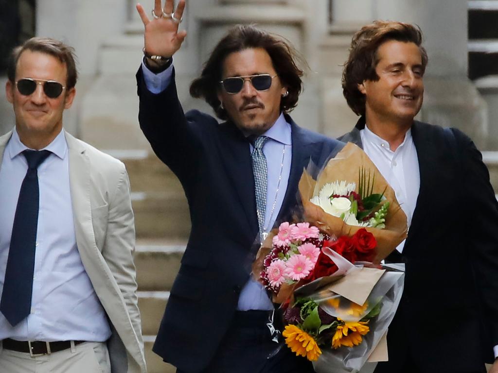 Johnny Depp holds bunches of flowers as he leaves after a hearing in his libel trial against News Group Newspapers (NGN), at the High Court in London. Picture: Tolga Akmen/AFP