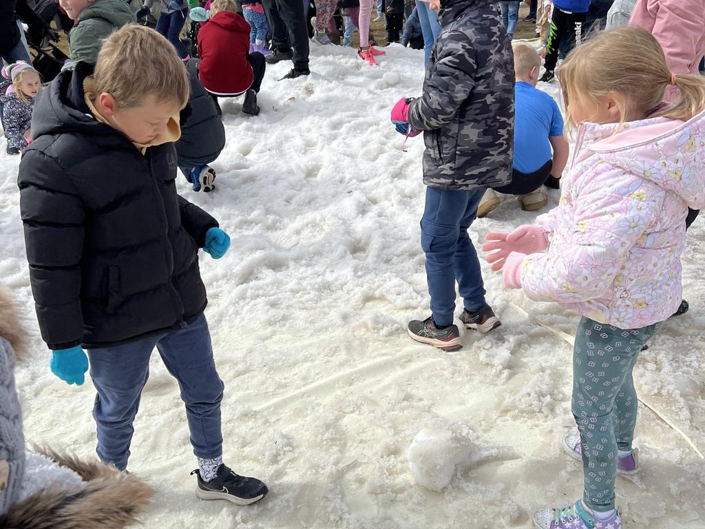 Watch out for that snowball! Connor (L) and Aria (R) playing in the snow field at Snowflakes in Stanthorpe on Saturday, July 1 2023.