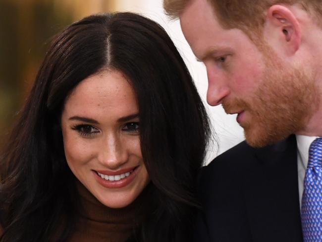 (FILES) In this file photo taken on January 10, 2020 Britain's Prince Harry, Duke of Sussex and Meghan, Duchess of Sussex react during their visit to Canada House in thanks for the warm Canadian hospitality and support they received during their recent stay in Canada, in London. - The Canadian government has yet to decide whether it will assume the security costs associated with Prince Harry and Meghan Markle's decision to split their time between Canada and Britain, Prime Minister Justin Trudeau said January 13, 2020. "I think that is part of the reflection that... needs to be had, and there are discussions going on," Trudeau said in an interview with Canadian television channel Global. (Photo by DANIEL LEAL-OLIVAS / various sources / AFP)